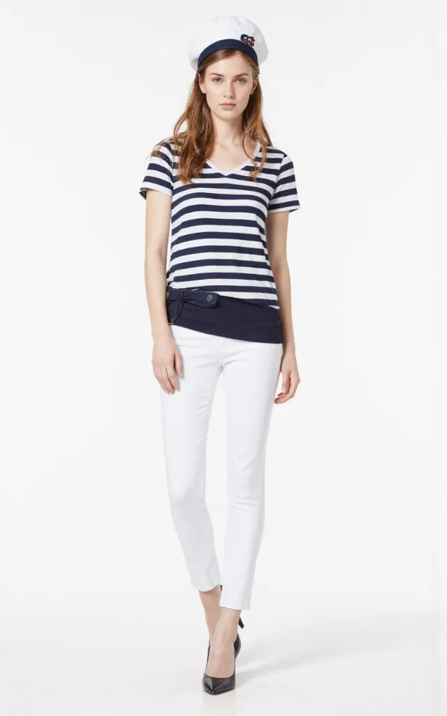 A French female model wearing Nautical   style clothing, against a white background, in a front   facing shot focusing on shoes